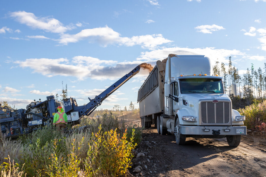 Grinding loading into a truck for pellet production in BC