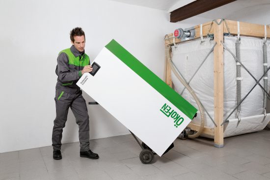 Person moving wood pellet boiler.