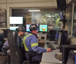 people looking at screens in a pellet mill