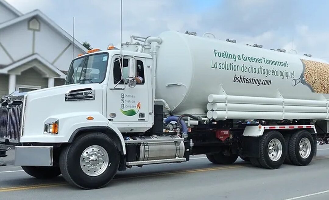 a wood pellet truck driving down a road