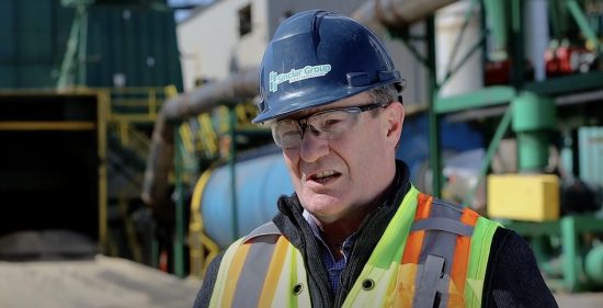 Person in safety gear, speaking to someone beside the camera.